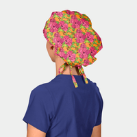 Person wearing a colorful floral scrub hat on a plain background