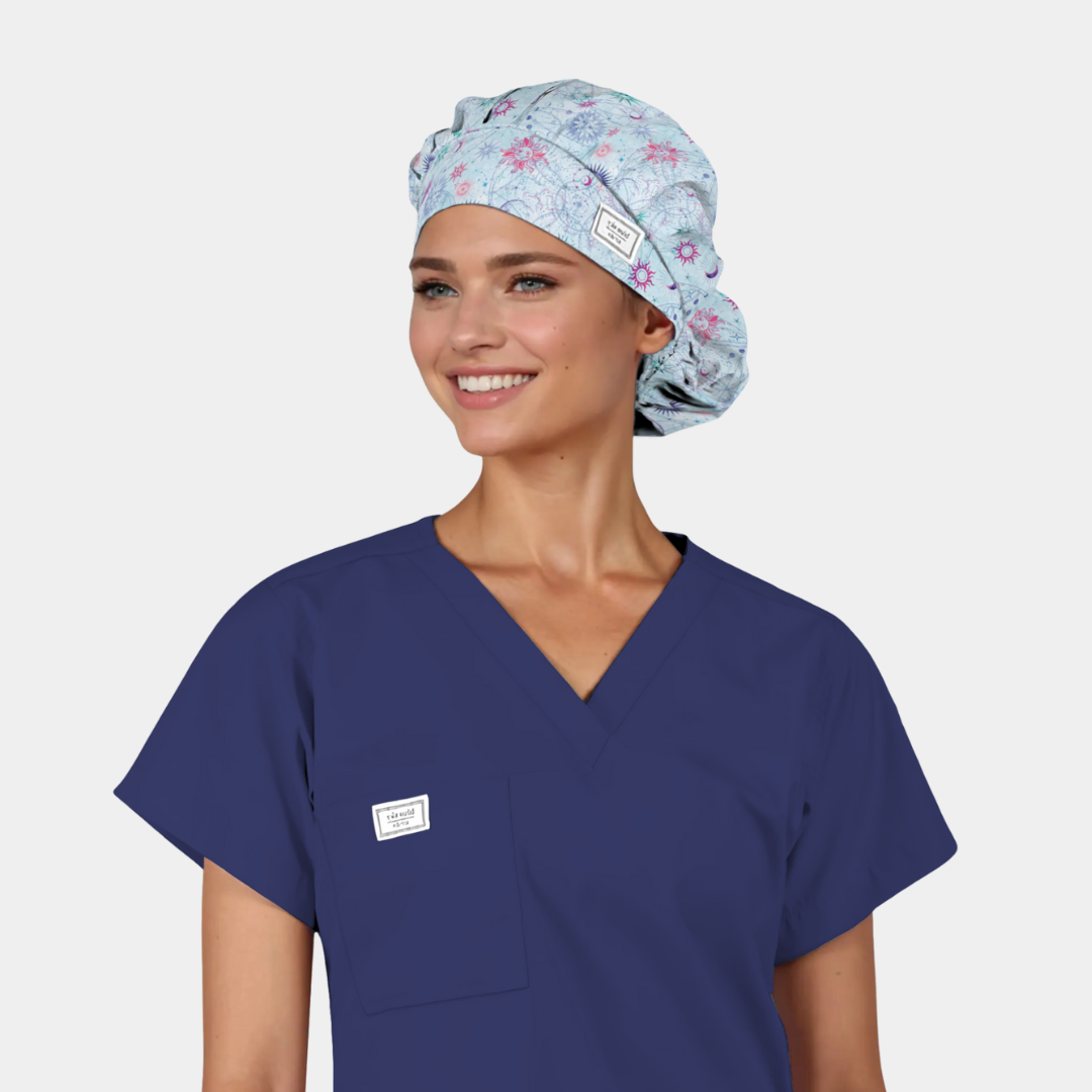 woman wearing a light blue bouffant scrub cap and a navy blue scrub top 