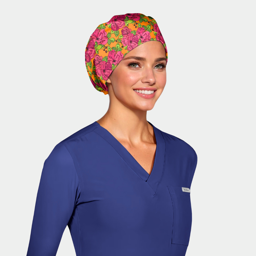Woman wearing a blue scrub top and colorful floral headscarf on a light gray background
