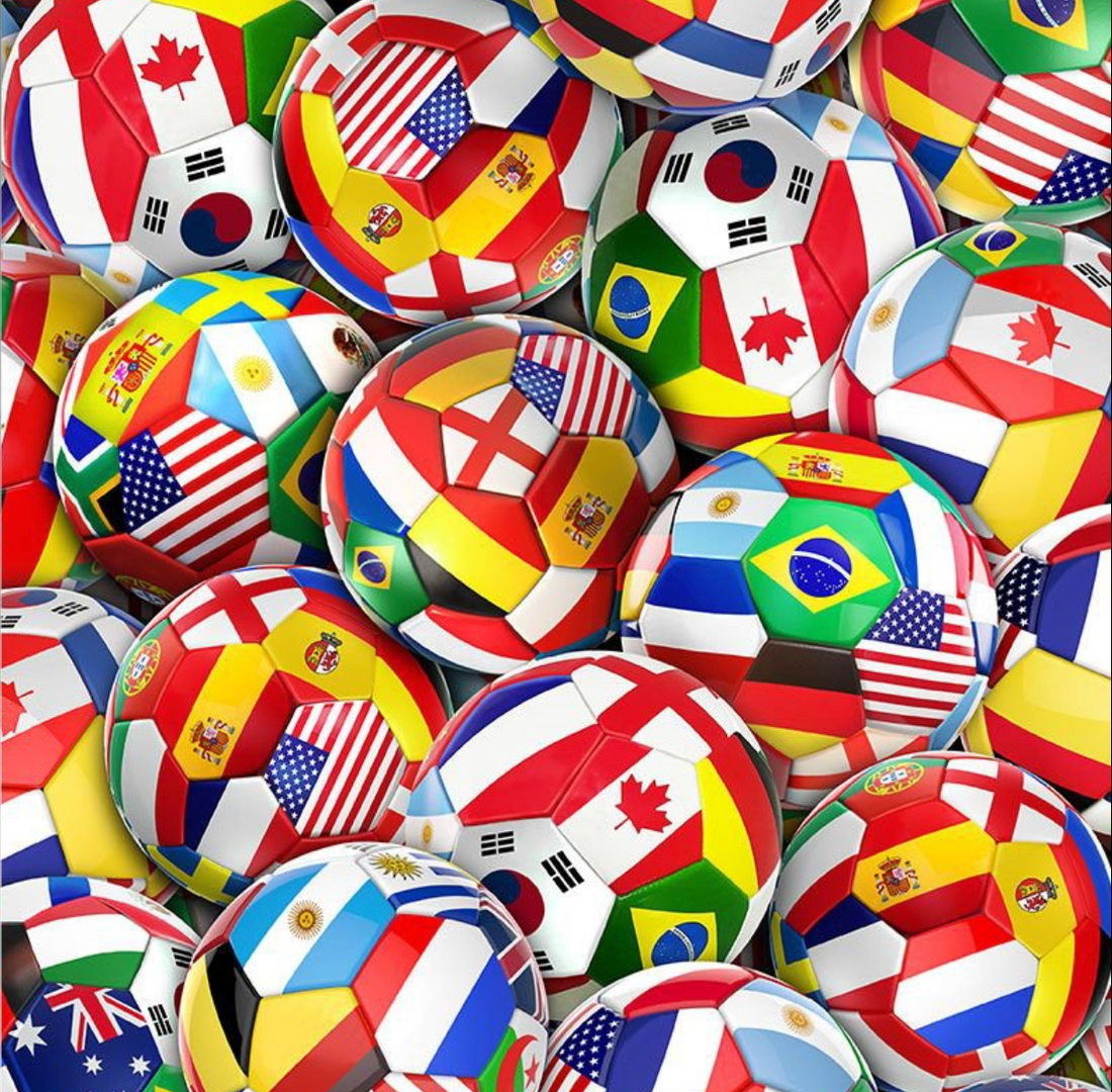 Collection of small soccer balls with various national flags on a colorful background