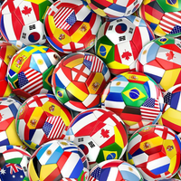 Collection of small soccer balls with various national flags on a colorful background