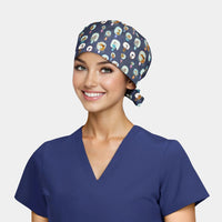 woman wearing a navy blue scrub top and a navy scrub hat with dogs on it all on a white background