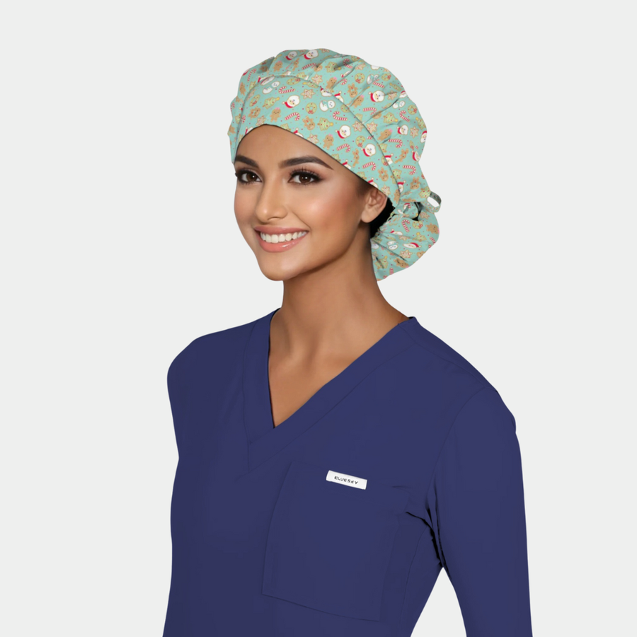 woman wearing a navy blue scrub top and a christmas scrub hat that is light green with Santas on it