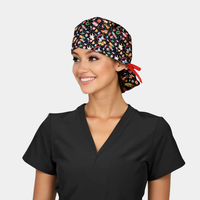woman wearing a black scrub top and a christmas ponytail scrub cap on a white background