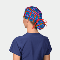 Person wearing a colorful ponytail scrub cap with a blue shirt on a white background