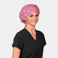 woman wearing a black scrub top and a pink bouffant scrub hat with zebras on it