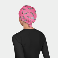 woman wearing a black scrub top and a pink surgical hat with zebras on it